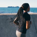 girl running nearby sea wall