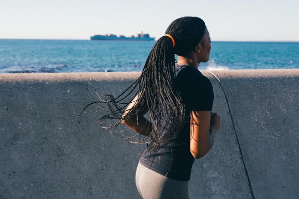 girl running nearby sea wall